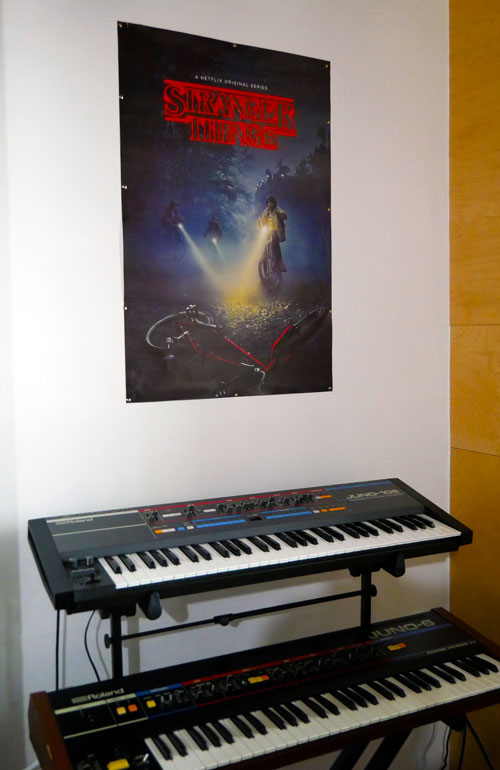 Roland Juno-6 and Juno-106 boards have a place of honor under the Stranger Things poster at Synth House Chicago.