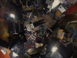 Overhead view of musicians and their instruments arranged throughout a practice space.