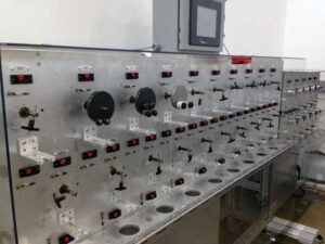 A control panel for cable testing equipment with numerous switches and displays.