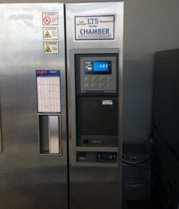 A large LTS temperature testing chamber displays a digital readout with warning labels.