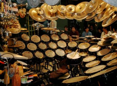 Terry Bozzio's massive custom drum kit with multiple drums and cymbals arranged on a dark stage.