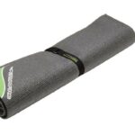 Rolled gray drum rug with green stripe bound by black fabric band.