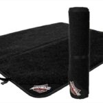 An Ahead brand black drum rug shown rolled and unrolled with company logo.