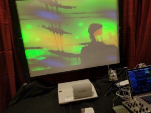 A thermal image displays people silhouetted against a textured background in green and yellow heat tones.