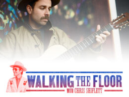 A bearded man plays an acoustic guitar in the Walking the Floor podcast branding.