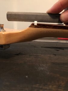 Photograph of guitar nut demonstrating flat string angle.