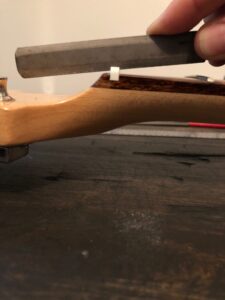 Photograph of guitar nut demonstrating proper string angle.