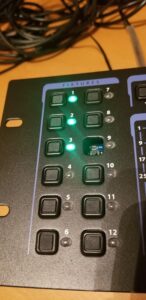 Fixture control panel displaying twelve numbered buttons with green status indicators.