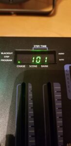 Close-up of DMX console display showing time counter and navigation buttons.