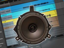 Subkick microphone positioned in front of a digital audio workstation with colored audio tracks.
