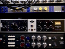 Professional audio equipment including Focusrite and Universal Audio units stacked in a rack.