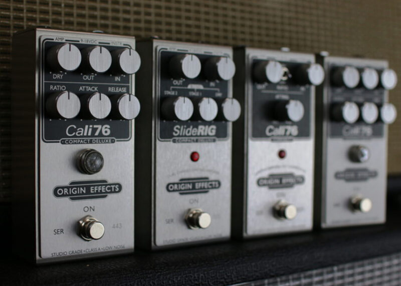 Four Origin Effects guitar pedals including Cali76 and SlideRIG arranged in a row.