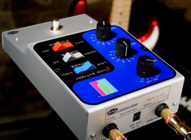 A white and blue Mu-Tron Mutronic guitar effects pedal with colored control buttons and knobs on display.
