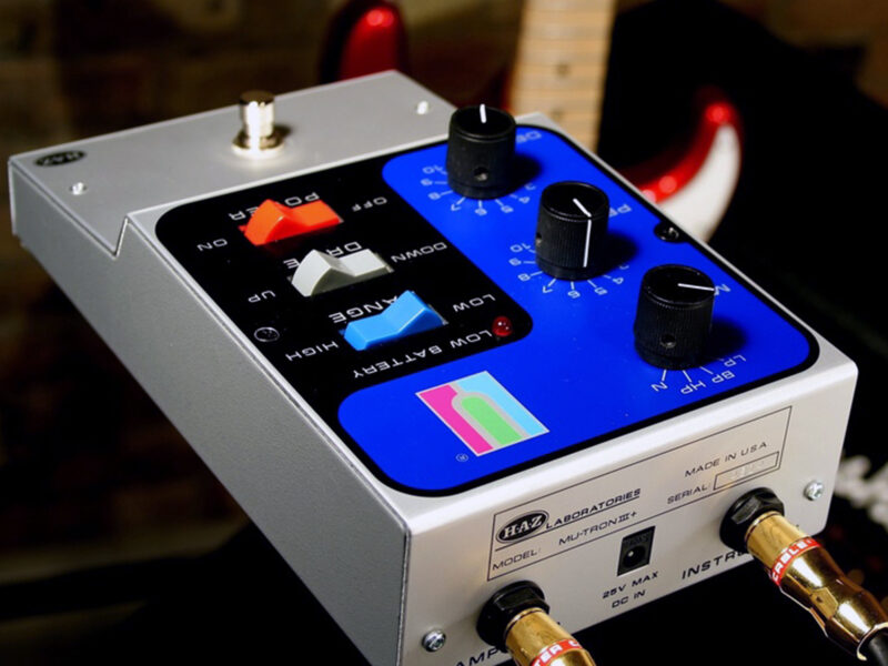 A white and blue Mu-Tron Mutronic guitar effects pedal with colored control buttons and knobs on display.