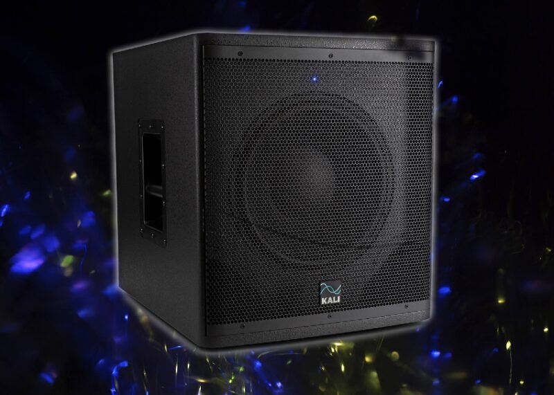 Black Kali audio speaker with perforated grille surrounded by blue and yellow bokeh lights on dark background.