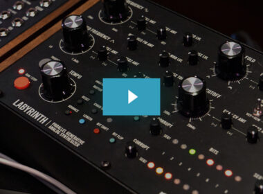 The Moog Labyrinth synthesizer displays multiple black knobs, colored button controls, and a wooden accent panel.
